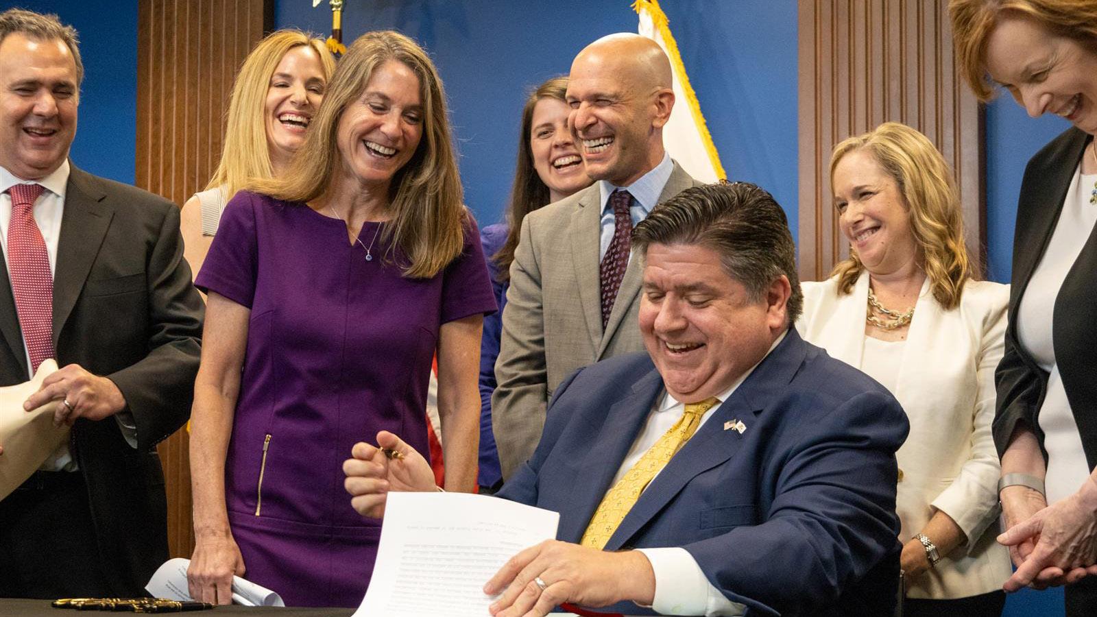 Oh, I signed!  says State Senator Laura Fine, D-Glenview, as she realizes that her bill giving the Department of Insurance new oversight authority was approved by Gov. JB Pritzker on June 27, 2023. (Andrew Adams/Capitol Illinois News)